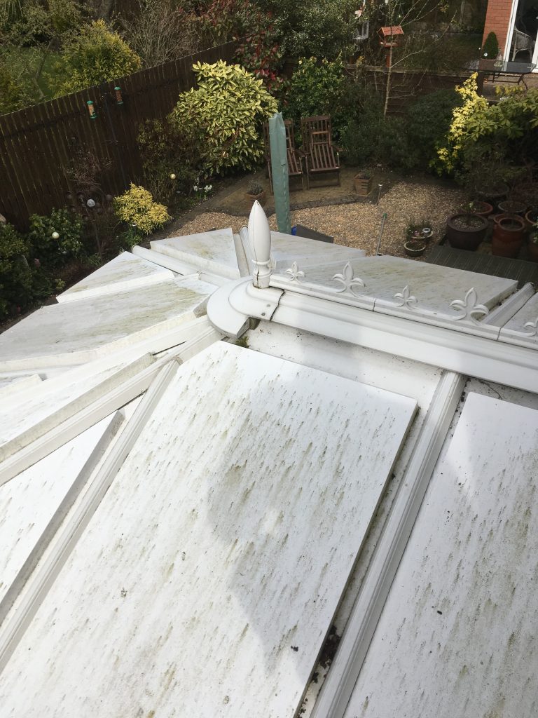 This image shows a conservatory roof before it has been cleaned.